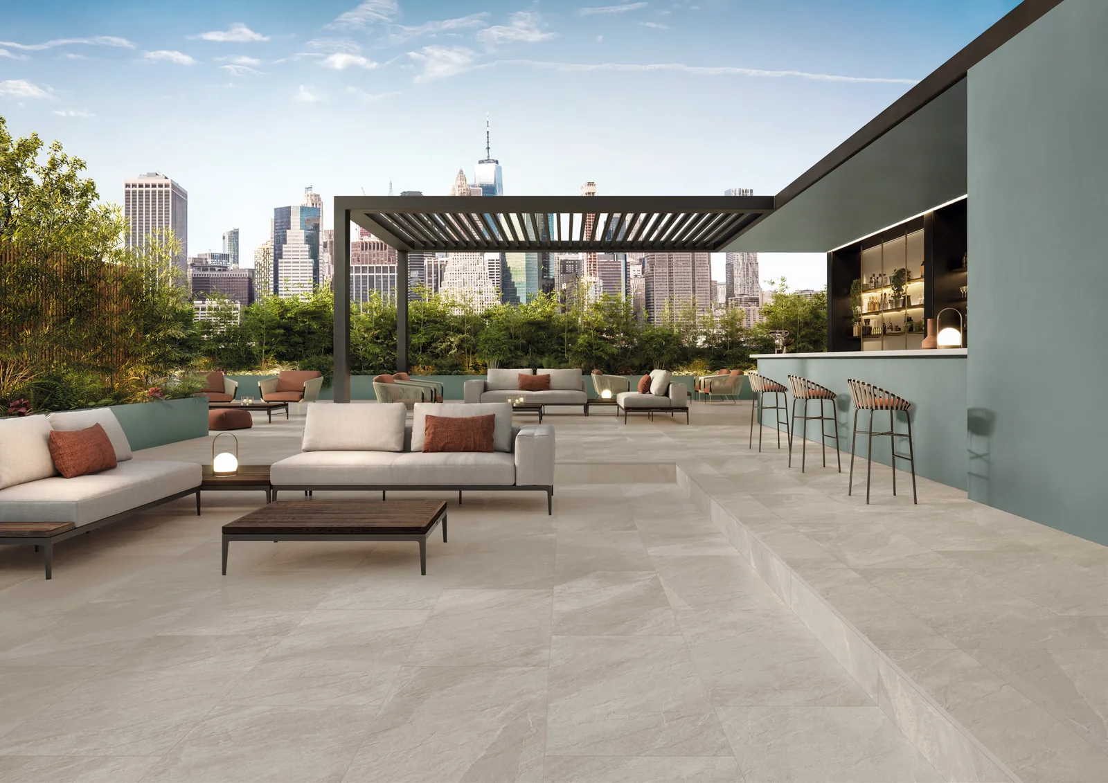 Dachterrasse mit beigebraunen Außenplatten in Schieferoptik, Loungemöbeln, Pergola und Blick auf die Skyline