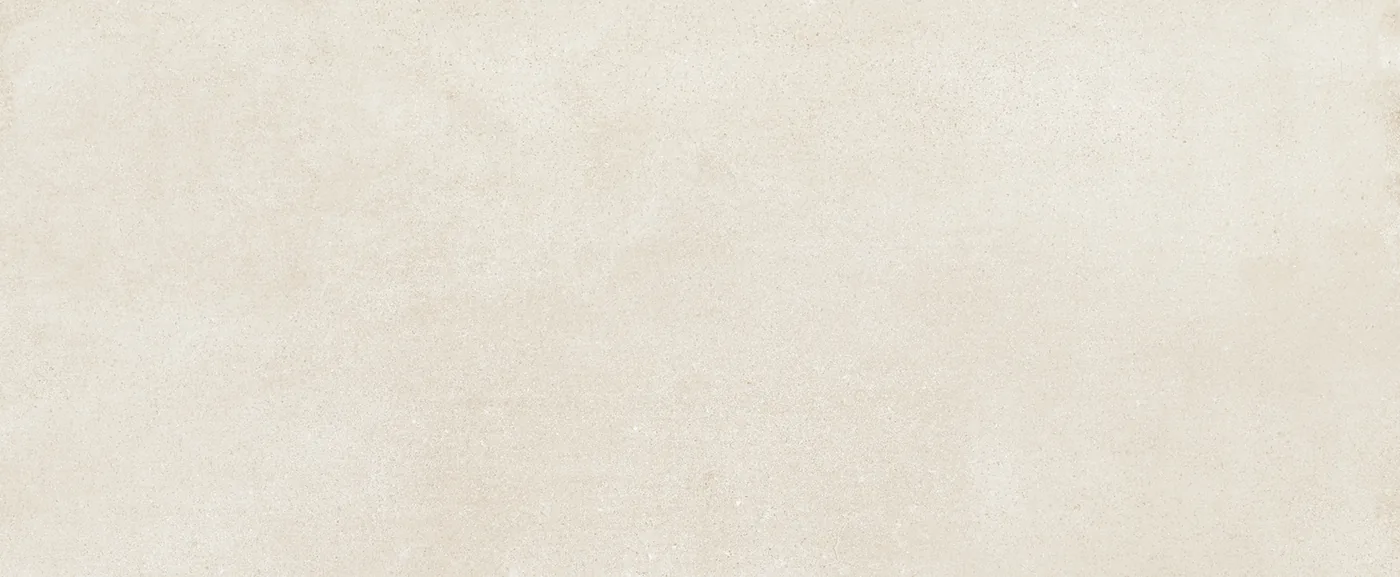 Sandfarbene Wandfliese 20×50 cm mit gleichmäßig durchgefärbter Fläche und feiner Körnung im Betonlook.