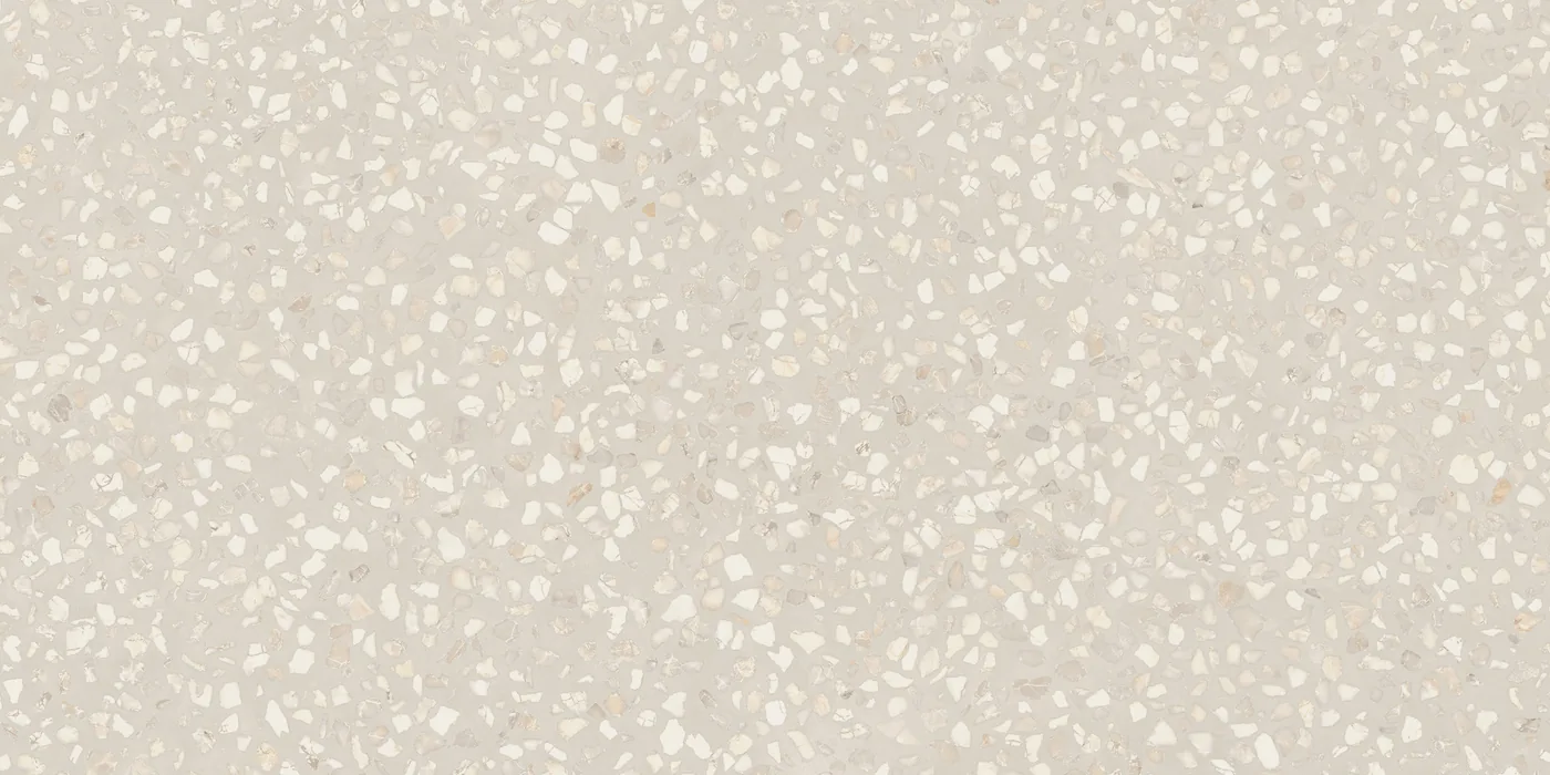 Cremeweiße Terrazzo-Fliese 30×60 cm, matt, mit dicht gestreuten hellen Marmorsplittern über die Fläche.