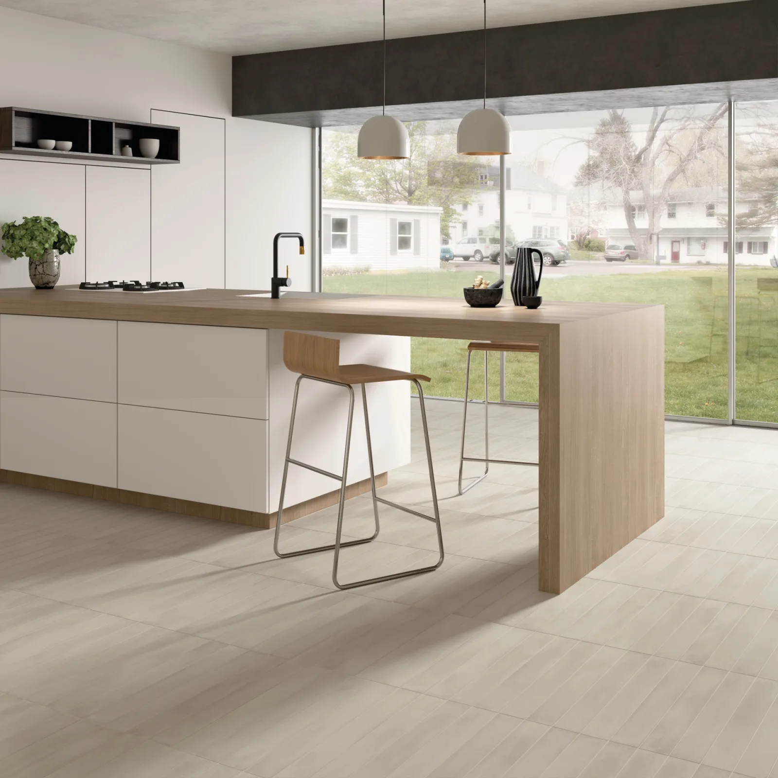 Offene Küche mit greigem Boden aus Stonella Silver Breeze, weißer Kücheninsel und Blick in den Garten