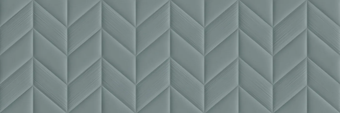 Graublaue matte Wandfliese 30×90 cm mit plastischem Fischgrätrelief Ton in Ton, frontal aufgenommen.