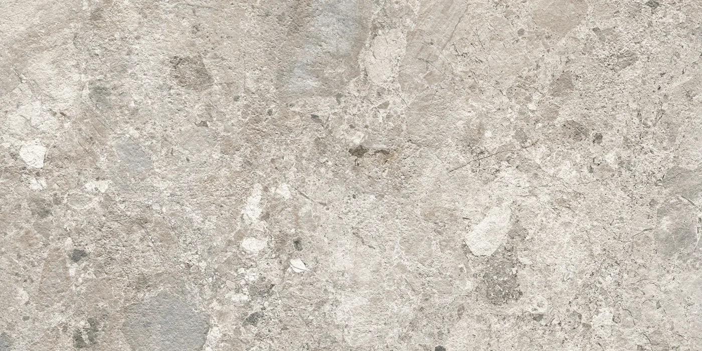 Graue Fliese 30×60 cm in Terrazzo-Optik mit hellen und dunkelgrauen Steinsplittern unterschiedlicher Größe.