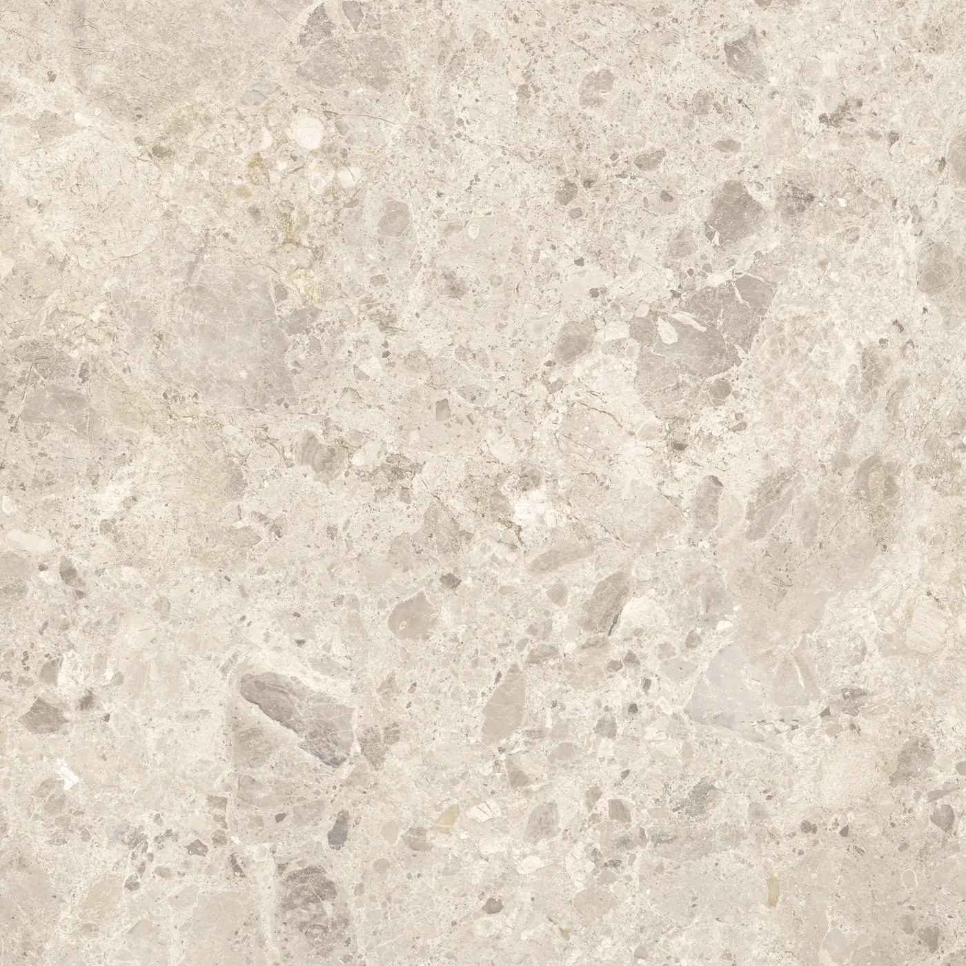 Beige Fliese 100×100 cm in Terrazzo-Optik mit grauen und hellen Steinsplittern unterschiedlicher Größe auf heller Fläche.