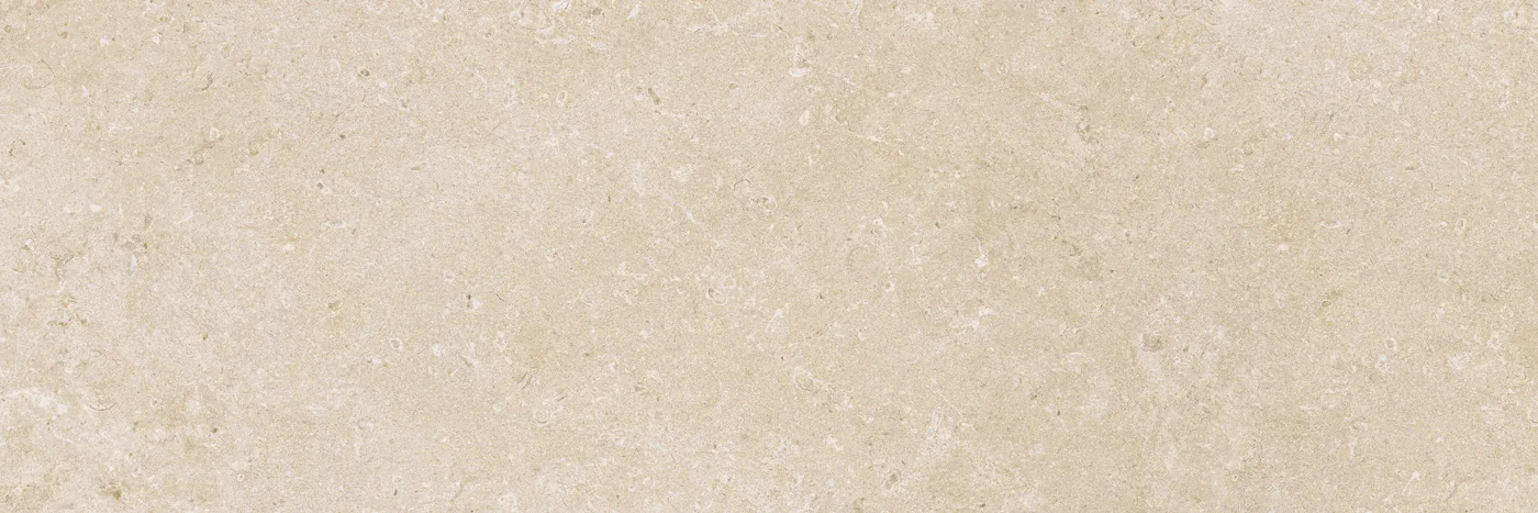 Sandbeige Wandfliese 30×90 cm in matter Kalksteinoptik mit feinen helleren Einschlüssen und gewolkter Oberfläche.