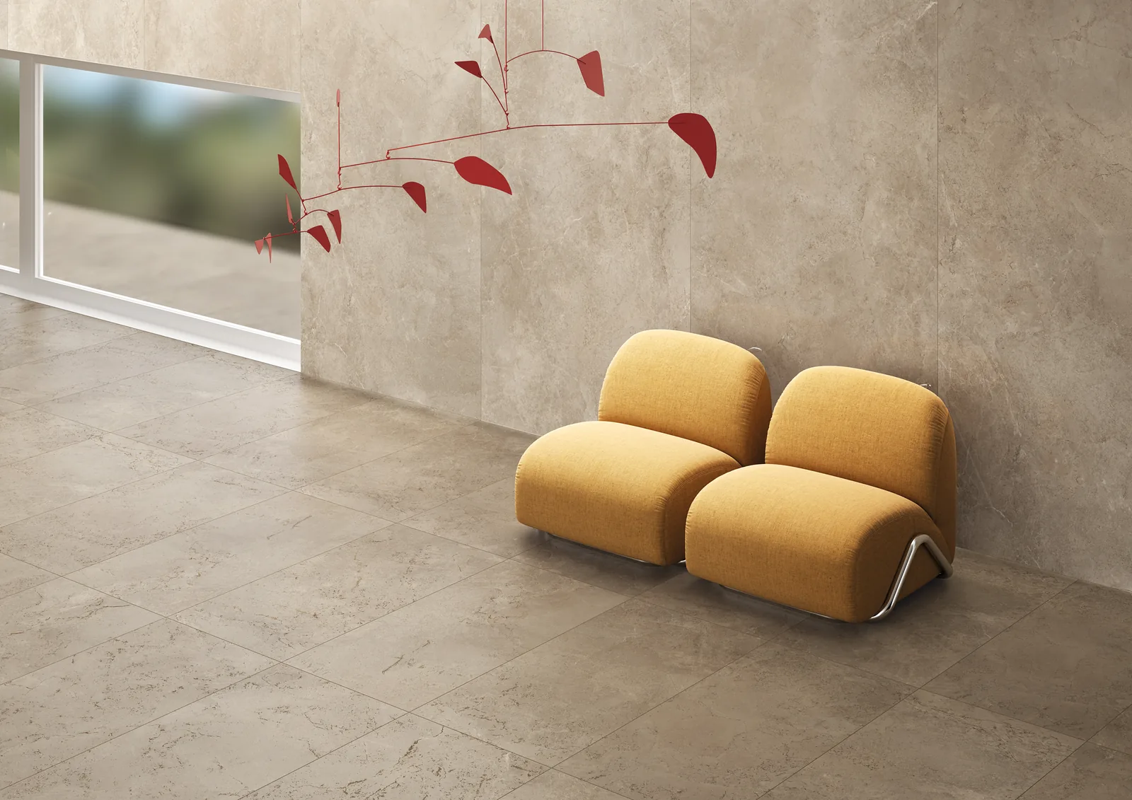 Taupefarbener Steinoptik-Boden und großformatige Wandplatten, davor zwei gelbe Sessel und ein rotes Mobile.