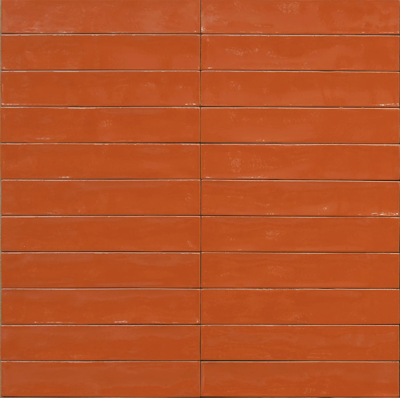 Glänzende Wandfliese 5,3x30 cm in kräftigem Orangerot, schmale Riemchen mit leicht welliger Glasur und unregelmäßigen Kanten