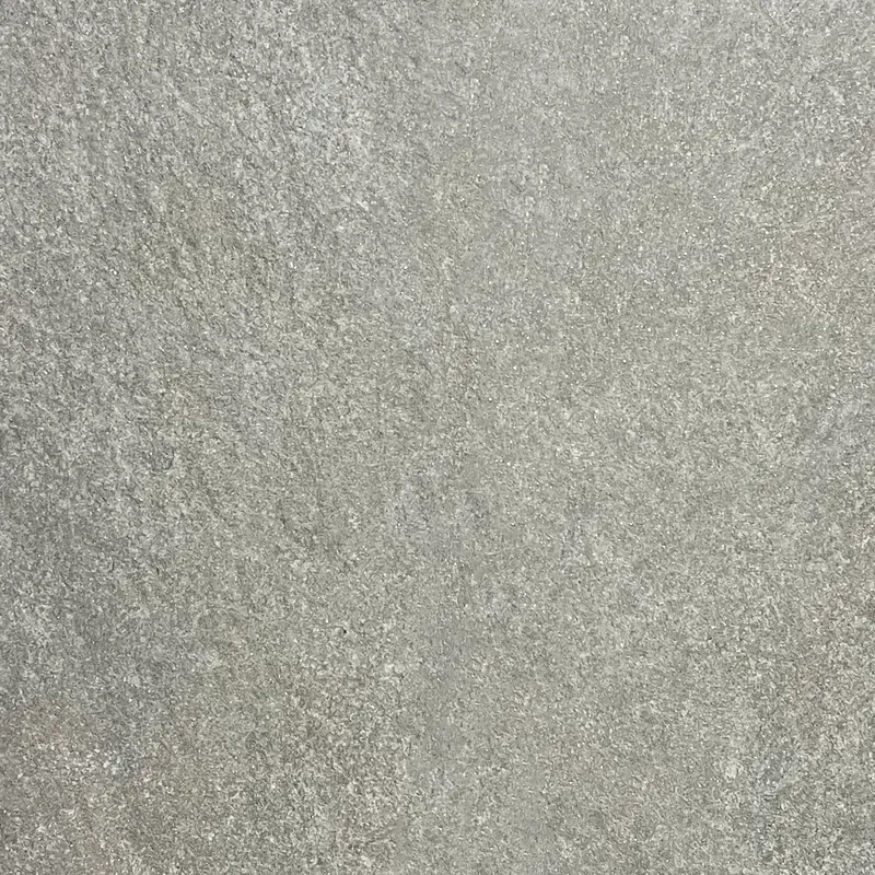 Nahaufnahme einer mittelgrauen Steinoberfläche mit feiner, leicht wolkiger Maserung in Grautönen.