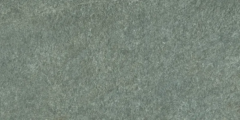 Nahaufnahme einer warm-anthrazitfarbenen Steinoberfläche mit feiner, dunkler Beton-Maserung.
