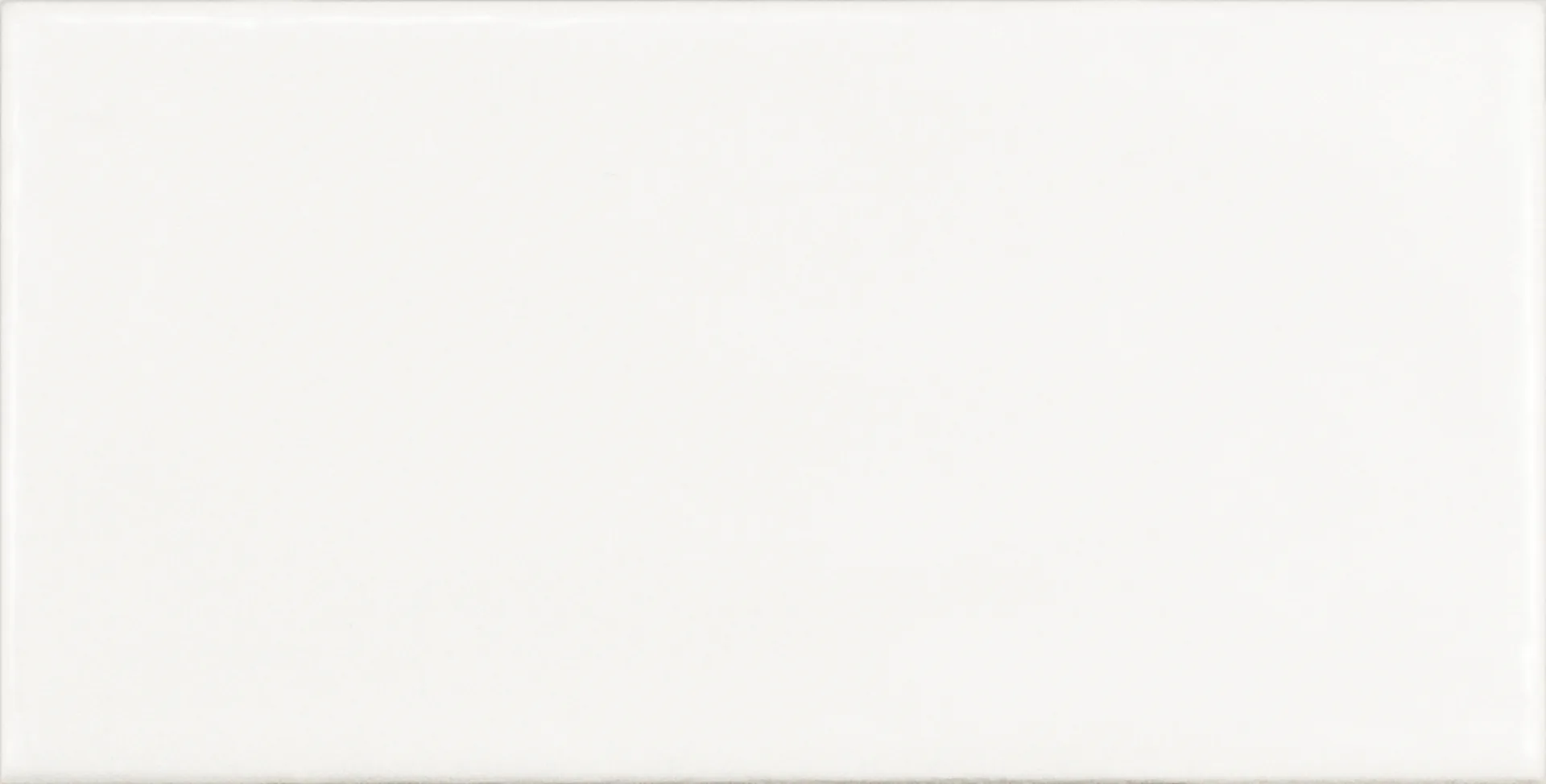 Einzelne weiße Rechteckfliese mit matter Glasuroberfläche im Format 7,5×15 cm und sanften Lichtreflexen.