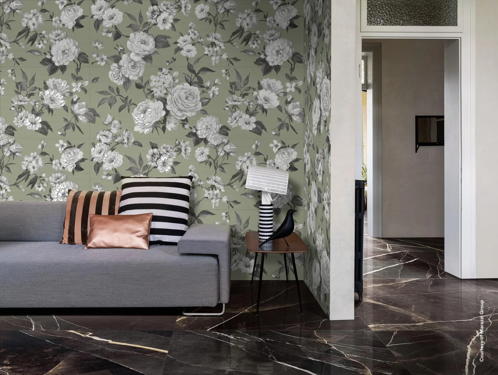 Wohnzimmer mit grauem Sofa vor Blumentapete, Boden in schwarzer Marmoroptik mit weißen und goldenen Adern.