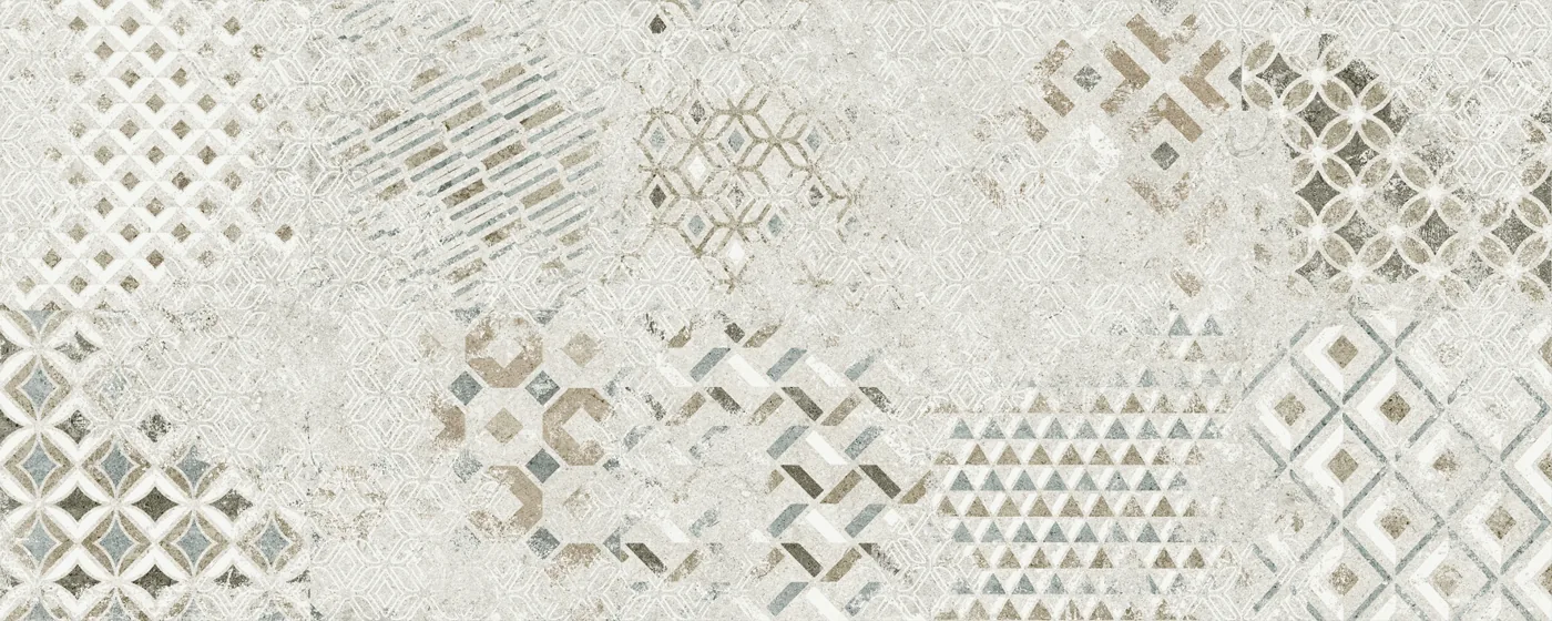 Graues Patchwork-Dekor im Format 40×100 cm, matt, mit Rauten, Dreiecken und Waben auf Steingrund.