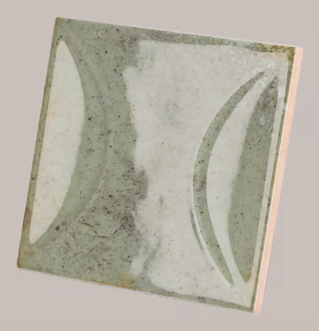 Hanoi Wandfliese in Celadon Glasur, Format 10x10 cm, schräge Studio Aufnahme mit sichtbarem Glasurglanz.